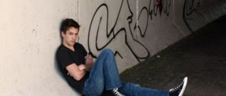 Lonely guy sitting on the ground in an underpass