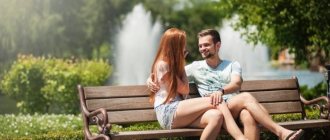 A guy and a girl are sitting on a bench